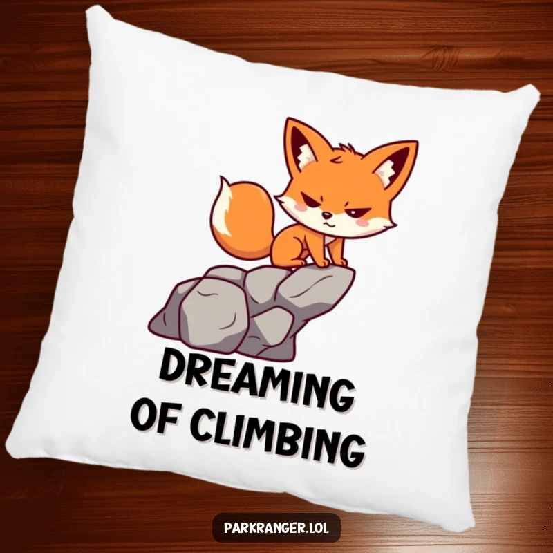 Funny pillow featuring a small, determined fox character with a playful grin, climbing a stylized rock.