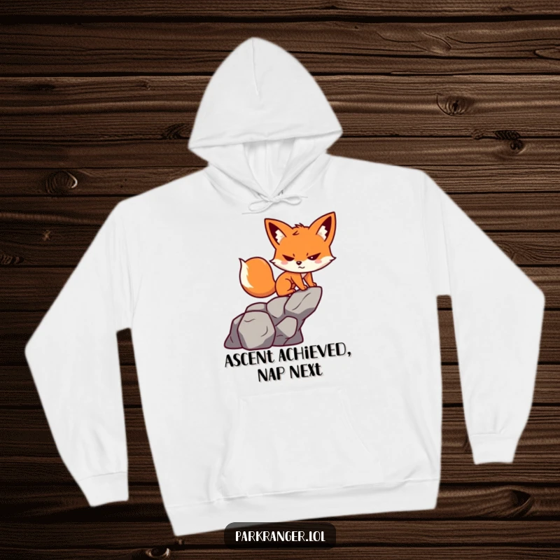 Funny hoodie showing a small, determined fox character joyfully scaling a rock formation with a playful grin.
